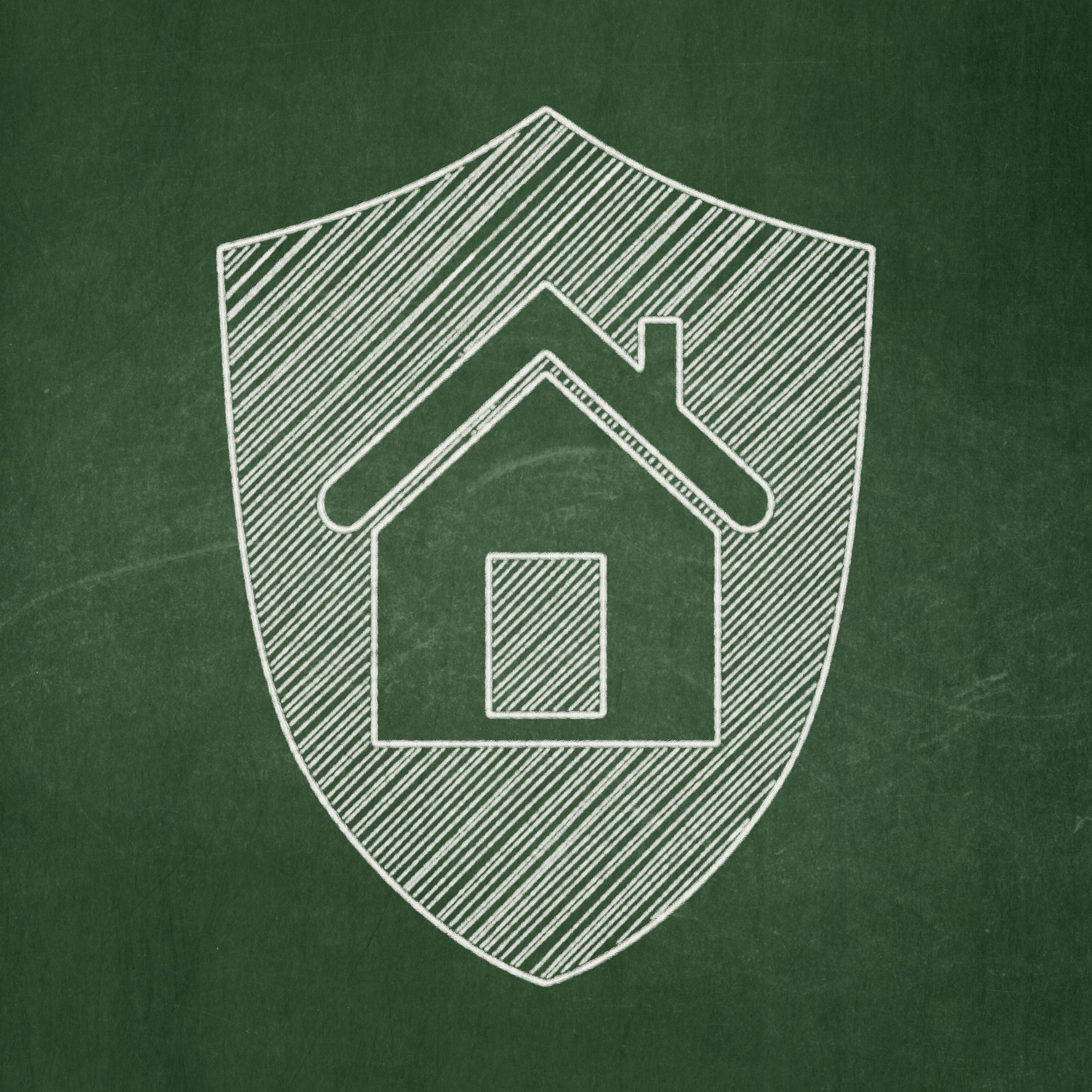 A finance concept of a shield on a chalkboard background